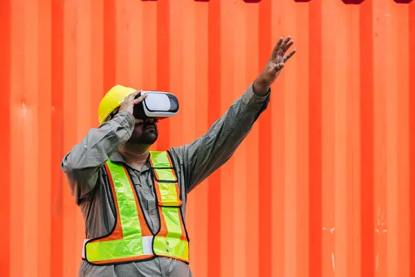 stock image Worker Using VR Vision Pro Technology Equipment Headset Device Work at Container Yard Construction site Innovation in Logistics Industry