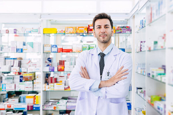 Pharmacist man smart arm crossed in Pharmacy health service in drugstore, professional doctor in medicine shop medication healthcare people.