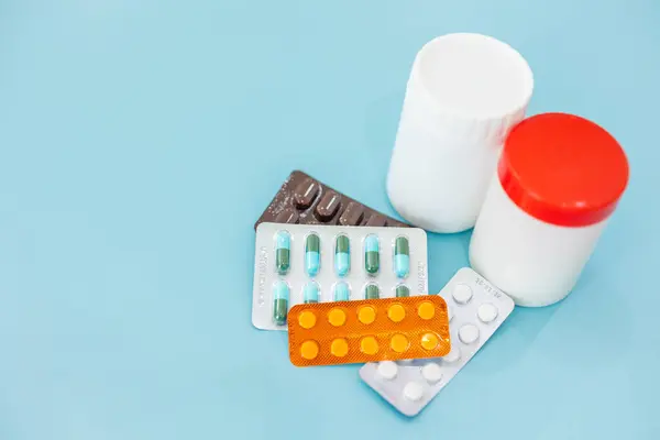 stock image mix type of medicine caps pills and capsule on clean blue color background blank copy space for text, using medicine for healthcare concept.