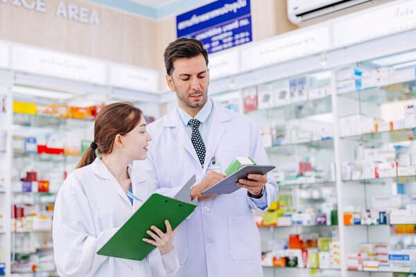 Pharmacy working people team stuff standing talking together in drugstore, Pharmacist male and female working cooperate.