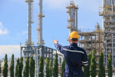 Rafineri petrol işçisi görev başında, telsiz kontrol operasyonu. Petrol ve gaz endüstrisi mühendisi petrokimya fabrikasında çalışıyor..