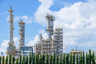 Petrochemical Petroleum Refinery Oil and Gas plant industrial complex building with Atmospheric distillation tower landscape summer blue sky. clipart