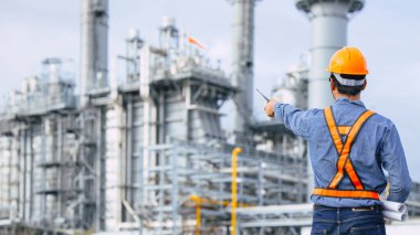 Petrol Rafineri endüstrisi mühendisi erkek petrol ve doğalgaz sanayi fabrikasına karşı çalışıyor. Petrokimya sanayii profesyonel işçisi.