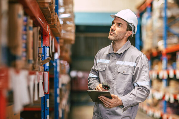 Warehouse worker working check inventory at shelf with barcode scan, Cargo employee staff in duty storage warehouse building