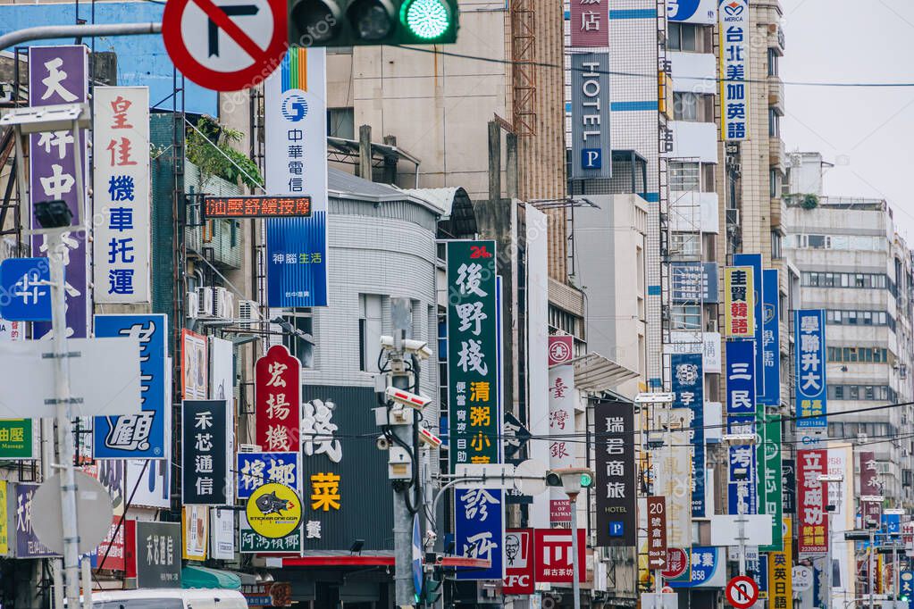 Chinese-Taipei. April 20 2025: Taichung Business downtown street crowded of shop sign brand logo Chinese language at Taiwan business center city