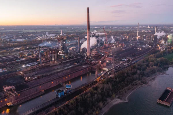 Metallurgical Plant in North Rhine-Westphalia at dawn. In addition to a steel mill, it operates a coke plant, blast furnaces, a power plant and a sinter plant.