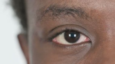 Close Up of One Blinking Eye of Casual African Man