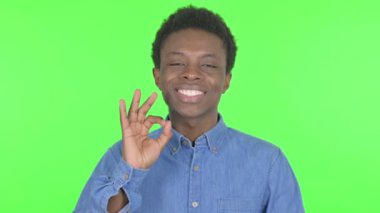 Casual African Man with Ok Sign on Green Background
