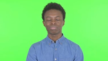 Disapproval by Casual African Man on Green Background