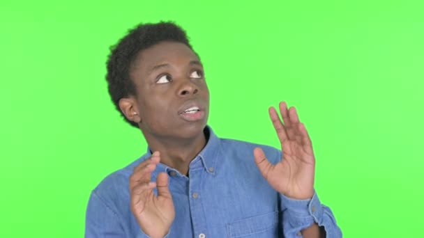 Casual African Man Feeling Scared Frightened Green Background — Stockvideo
