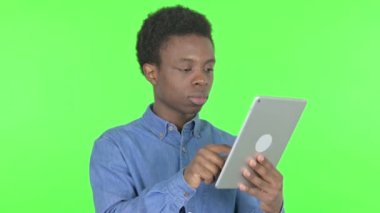 Casual African Man with Loss on Tablet on Green Background