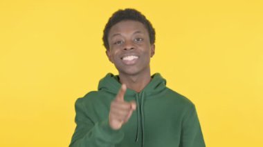 Casual African Man Pointing at the Camera on Yellow Background