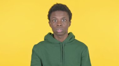 Wondering Casual African Man Feeling Shocked on Yellow Background