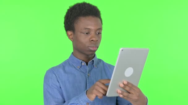 Casual African Man Using Digital Tablet Green Background — Stockvideo