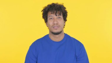 Thumbs Up by Casual African Man on Yellow Background