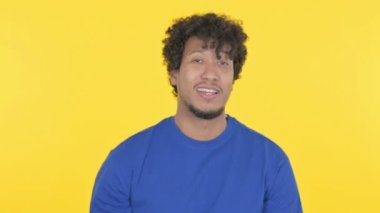 Casual African Man Talking on Online Video Call on Yellow Background