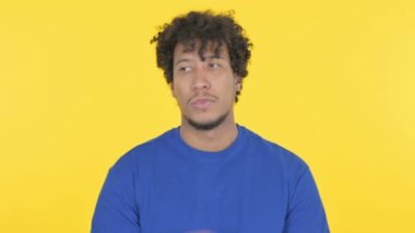 Casual African Man with Neck Pain on Yellow Background