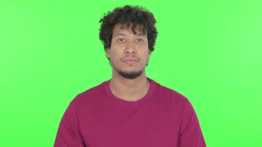 Serious Casual African Man on Green Background