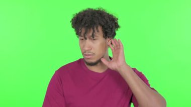 Casual African Man Listening Secret Information on Green Background