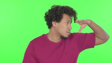 Casual African Man Searching Opportunity on Green Background