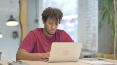 Young African Man Leaving Office after Closing Laptop