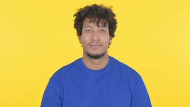黄色の背景に笑顔カジュアルアフリカ人男性 — ストック動画