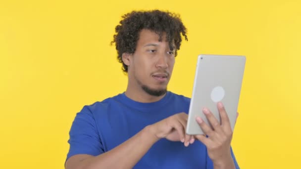 Casual African Man Celebrating Success Tablet Yellow Background — 비디오