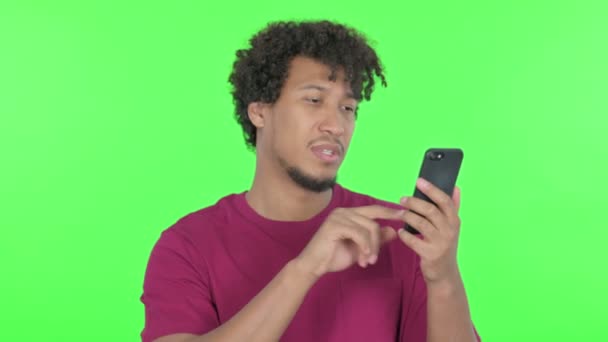 Casual African Man Celebrating Smartphone Green Background — 비디오