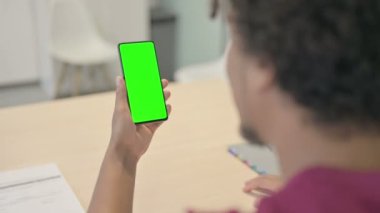 Young African Man Using Smartphone with Chroma Key