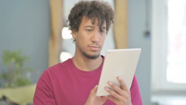 Young African Man Browsing Internet Digital Tablet — Vídeo de stock