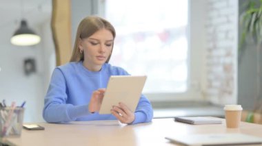 Young Woman using Digital Tablet, Browsing Internet