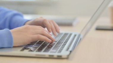 Side View of Young Woman Typing on Laptop, Close up