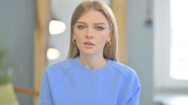 Young Woman Yawning while Sitting in Creative Place