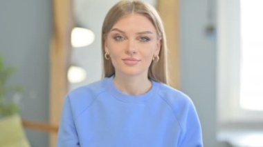 Young Woman Offering Dollar Bills in Creative Office