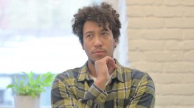 Portrait of Thinking Young African Man Having New Plan