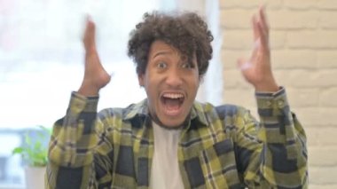 Distraught Young African Man Shouting in Anger and Stress
