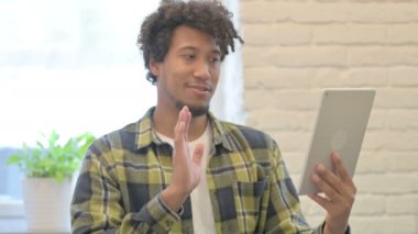 Young African Man Doing Online Video Chat on Tablet