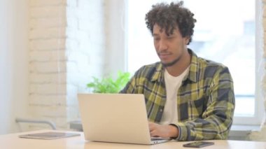 Young African Man Reacting to Loss While Working in Office