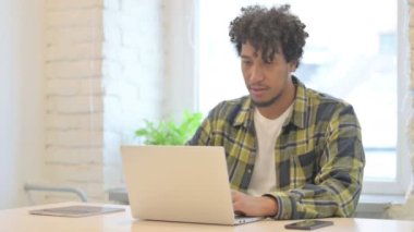 Young African Man in Depression and Anxiety Working in Office