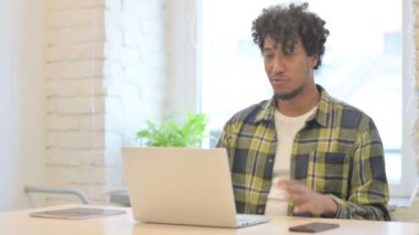 Online Video Chat on Laptop by Young African Man in Office