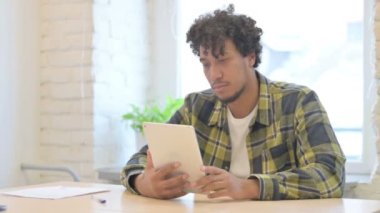 Shocked Young African Man Reacting to Loss on Digital Tablet