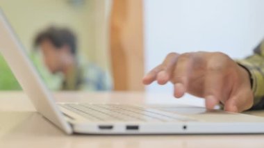 Side View of Young African Man Working on Laptop, Close up