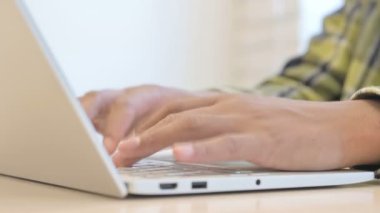 Young African Man Hands Typing on Laptop