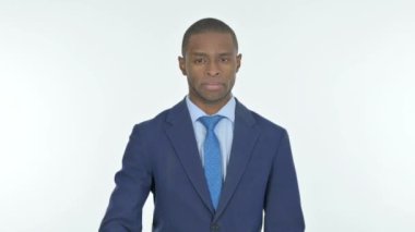 Thumbs Down by Young African Businessman on White Background