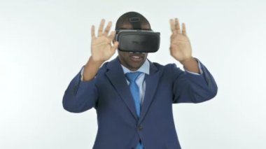 Young African Businessman Using VR Headset on White Background
