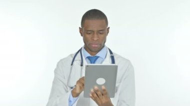 Young African Doctor Using Digital Tablet on White Background