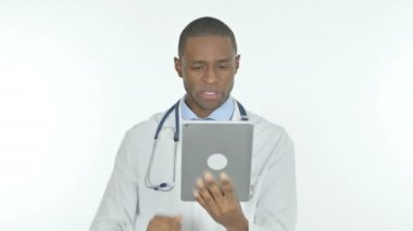 Video Call on Tablet by Young African Doctor on White Background