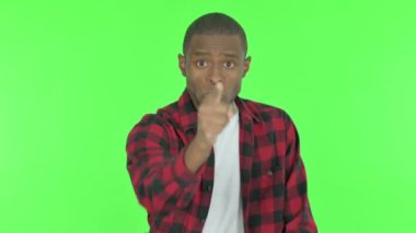 Angry Young African Man Arguing on Green Background