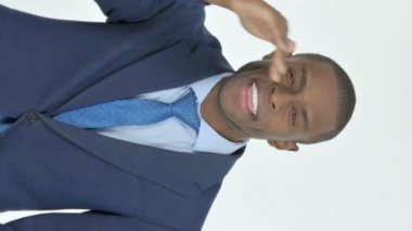 Vertical Video of Searching Young African Businessman on White Background