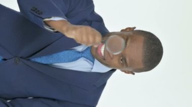 Vertical Video of Young African Businessman Searching with Loupe on White Background